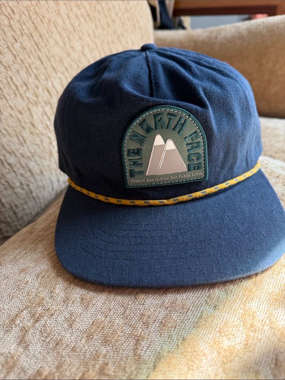 The North Face Navy Hat with Yellow Rope and Mountain Patch